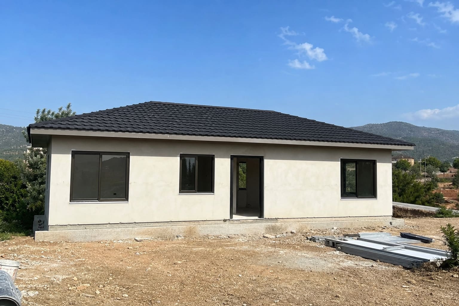 Stage 1 — steel-frame shell on a Cyprus plot during the build programme